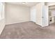 Bedroom with neutral carpet, large window, and open door at 5671 Camilla Cellars Ct, Las Vegas, NV 89141