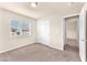 Bright bedroom features neutral carpet, a window with blinds, and a closet with double doors at 5671 Camilla Cellars Ct, Las Vegas, NV 89141