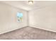 Bright bedroom with neutral carpet, a window providing natural light, and neutral paint at 5671 Camilla Cellars Ct, Las Vegas, NV 89141