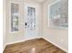 Charming entryway with decorative glass door, wood floors, and large windows to let in natural light at 5671 Camilla Cellars Ct, Las Vegas, NV 89141