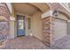 Inviting front porch with stone accents, decorative door, and brick-paved walkway leading to the entrance at 5671 Camilla Cellars Ct, Las Vegas, NV 89141