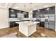 Contemporary kitchen with dark cabinetry, stainless steel appliances, and a granite-topped island at 5671 Camilla Cellars Ct, Las Vegas, NV 89141