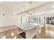 Bright, open space features a kitchen island with pendant lights and access to living areas at 5671 Camilla Cellars Ct, Las Vegas, NV 89141