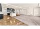 Expansive living space with hardwood and carpet flooring, leading to a bright kitchen area at 5671 Camilla Cellars Ct, Las Vegas, NV 89141