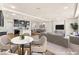 Inviting living room with an open floor plan and a modern kitchen in the background at 5671 Camilla Cellars Ct, Las Vegas, NV 89141