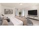 This staged main bedroom boasts neutral tones, stylish decor, and a seating area at 5671 Camilla Cellars Ct, Las Vegas, NV 89141