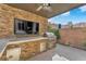 Covered outdoor kitchen complete with grill, sink, and modern appliances at 5671 Camilla Cellars Ct, Las Vegas, NV 89141