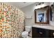 Bright bathroom featuring a granite vanity, framed mirror, and decorative shower curtain at 6745 Jackson Junction St, Las Vegas, NV 89149