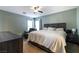 Comfortable carpeted bedroom with a ceiling fan, two windows and modern furnishings at 6745 Jackson Junction St, Las Vegas, NV 89149