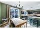 Bright dining area with modern light fixture and access to the backyard and contemporary kitchen at 6745 Jackson Junction St, Las Vegas, NV 89149