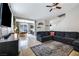 Inviting living room with tile flooring, a large sectional sofa, and an open layout at 6745 Jackson Junction St, Las Vegas, NV 89149