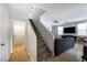Bright and airy living room leading to a carpeted staircase and a hallway entrance at 6745 Jackson Junction St, Las Vegas, NV 89149