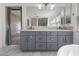 Stylish bathroom features a dual sink vanity with stone countertop and modern fixtures at 6909 Forest Gate St, North Las Vegas, NV 89084