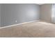 Bedroom features neutral paint, plush carpeting and a window to provide natural light at 6909 Forest Gate St, North Las Vegas, NV 89084
