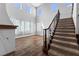 Inviting foyer featuring high ceilings, natural light, wood floors, and a staircase at 6909 Forest Gate St, North Las Vegas, NV 89084
