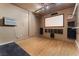 Spacious home theater room with large screen, track lighting, and wood-look flooring; ready for entertainment at 6909 Forest Gate St, North Las Vegas, NV 89084