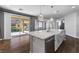 Modern kitchen with a granite countertop island, stainless steel appliances, and access to the backyard at 6909 Forest Gate St, North Las Vegas, NV 89084