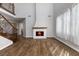Charming living room with wood-look flooring, a fireplace, and staircase at 6909 Forest Gate St, North Las Vegas, NV 89084