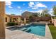 Backyard swimming pool with pergola, outdoor kitchen, and manicured landscaping at 6909 Forest Gate St, North Las Vegas, NV 89084