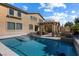Inviting backyard pool with patio area, outdoor kitchen, and partially covered entertainment space at 6909 Forest Gate St, North Las Vegas, NV 89084