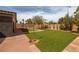Well maintained backyard with artificial turf and desert landscaping at 7180 White Bloom Ave, Las Vegas, NV 89117