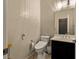 Compact powder room featuring a modern toilet and sleek vanity with sink at 7180 White Bloom Ave, Las Vegas, NV 89117