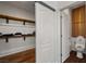 Modern bathroom with closet, new toilet, and unique wood paneling at 7180 White Bloom Ave, Las Vegas, NV 89117