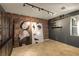 Cozy bedroom featuring a brick wall, track lighting, and industrial-style shelving with art display at 7180 White Bloom Ave, Las Vegas, NV 89117