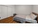 Comfortable bedroom featuring hardwood floors, double door closet, and neutral decor, ready for relaxation at 7180 White Bloom Ave, Las Vegas, NV 89117