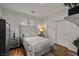 Stylish bedroom with modern decor, featuring a comfortable bed, sliding closet doors and hardwood flooring at 7180 White Bloom Ave, Las Vegas, NV 89117