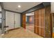 Inviting entryway with tiled floors, custom wood screen feature, and stylish decor at 7180 White Bloom Ave, Las Vegas, NV 89117