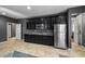 Kitchen boasts stainless steel appliances, sleek black cabinets, and tile flooring, perfect for modern living at 7180 White Bloom Ave, Las Vegas, NV 89117