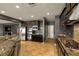 Open kitchen with stainless steel appliances, a kitchen island with a sink and granite countertops at 7180 White Bloom Ave, Las Vegas, NV 89117