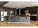 Spacious kitchen featuring dark cabinets, stainless steel appliances, and a granite countertop island at 7180 White Bloom Ave, Las Vegas, NV 89117