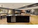 Open concept kitchen and living area with granite island, modern finishes, and ample natural light at 7180 White Bloom Ave, Las Vegas, NV 89117