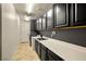 Functional laundry room with modern appliances, countertops, and cabinets for storage at 7180 White Bloom Ave, Las Vegas, NV 89117