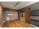 Stylish living space featuring hardwood floors, custom screen, brick accent wall and track lighting at 7180 White Bloom Ave, Las Vegas, NV 89117