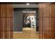 Living room view through a slatted screen of a designer wall and stylish artwork on display at 7180 White Bloom Ave, Las Vegas, NV 89117