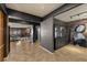 Open-concept living area with tile flooring, brick accent wall, modern lighting, and stylish decor at 7180 White Bloom Ave, Las Vegas, NV 89117