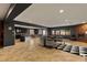 Open-concept living room with brick fireplace, large windows, and seamless flow to the kitchen and dining area at 7180 White Bloom Ave, Las Vegas, NV 89117