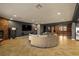 Expansive living room with fireplace and wood divider providing separation from the kitchen and dining spaces at 7180 White Bloom Ave, Las Vegas, NV 89117