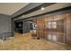 Bright living room with stylish wood slat divider, tile flooring, and easy access to other living areas at 7180 White Bloom Ave, Las Vegas, NV 89117