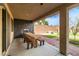 Beautiful covered patio with a built in wood table, fireplace and nicely landscaped yard at 7180 White Bloom Ave, Las Vegas, NV 89117