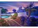 Lush backyard featuring a pool, landscaping, and a desert garden, perfect for outdoor enjoyment at 7405 Blue Sage Ct, Las Vegas, NV 89129