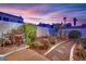 Charming backyard with desert landscaping, stone pathways, and seating area, perfect for relaxation at 7405 Blue Sage Ct, Las Vegas, NV 89129