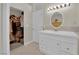 Bathroom featuring a closet and a white vanity with a sink at 7405 Blue Sage Ct, Las Vegas, NV 89129