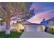 Charming single-story home features a red tile roof, attached two-car garage and a well-manicured front yard at 7405 Blue Sage Ct, Las Vegas, NV 89129