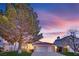 Charming single-story home features a red tile roof, attached two-car garage and a well-manicured front yard at 7405 Blue Sage Ct, Las Vegas, NV 89129