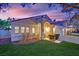 Charming single-story home features a red tile roof, arched entryway and a well-manicured front yard at 7405 Blue Sage Ct, Las Vegas, NV 89129