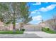 Charming single-story home features a red tile roof, attached two-car garage and a well-manicured front yard at 7405 Blue Sage Ct, Las Vegas, NV 89129